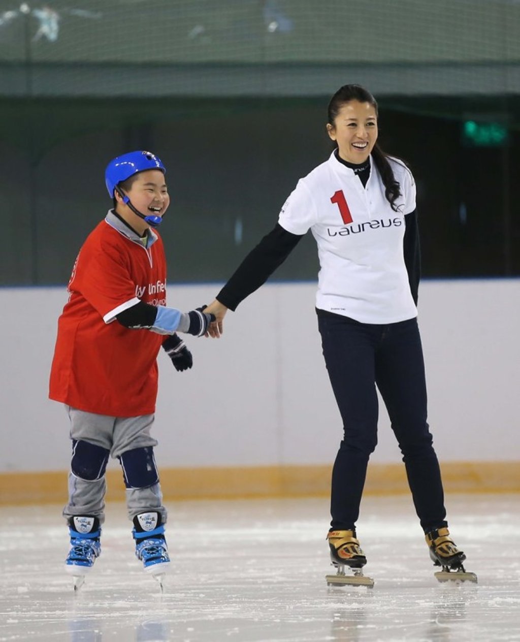 China’s first Winter Olympic champion Yang Yang (right) with a young skater at a Laureus Sport for Good project.