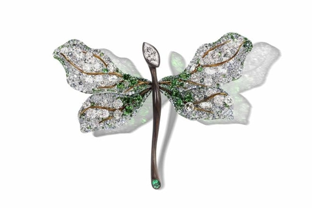The Dragonfly Brooch from the White Label Collection depicts a shimmering dragonfly flying over the water.