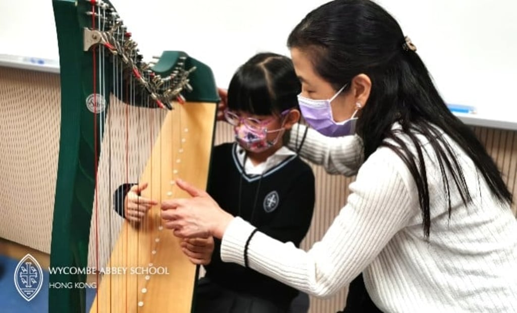 Student learning harp in our Intergrated Music Programme at school