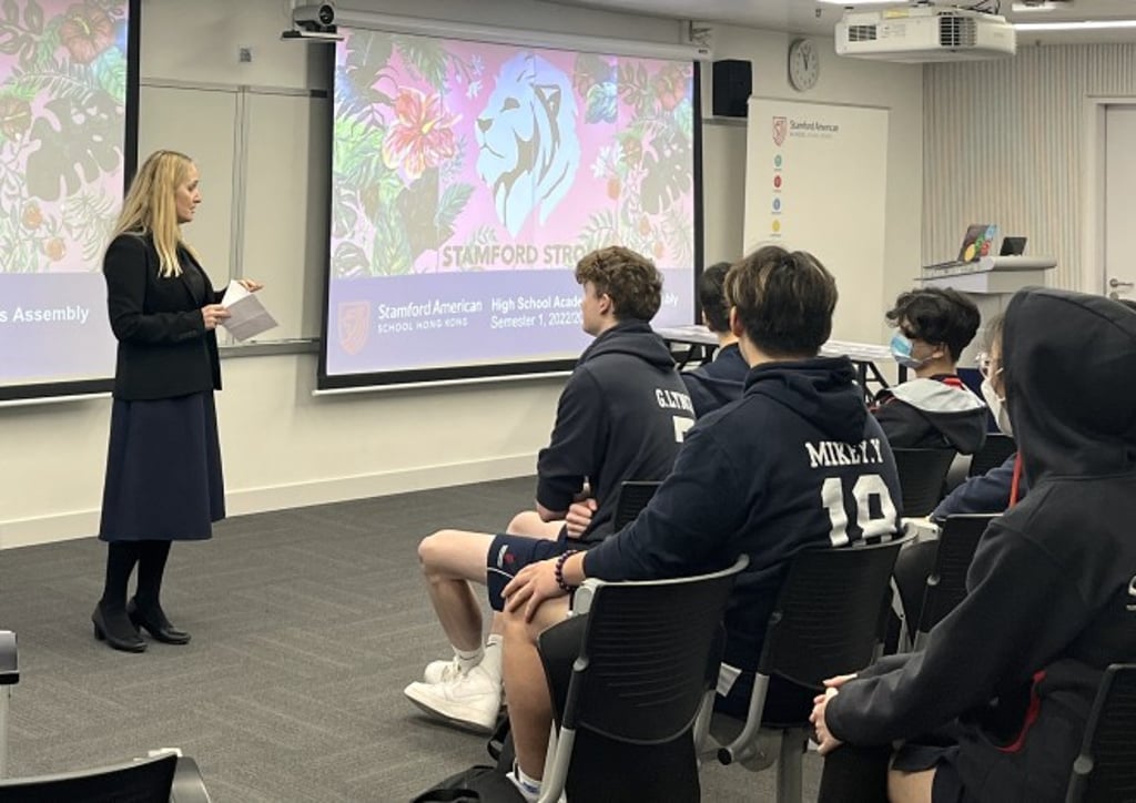 Secondary Principal Ms Foard celebrating student achievements at the end of semester awards recognizing excellence such as Honor Roll with Distinction.