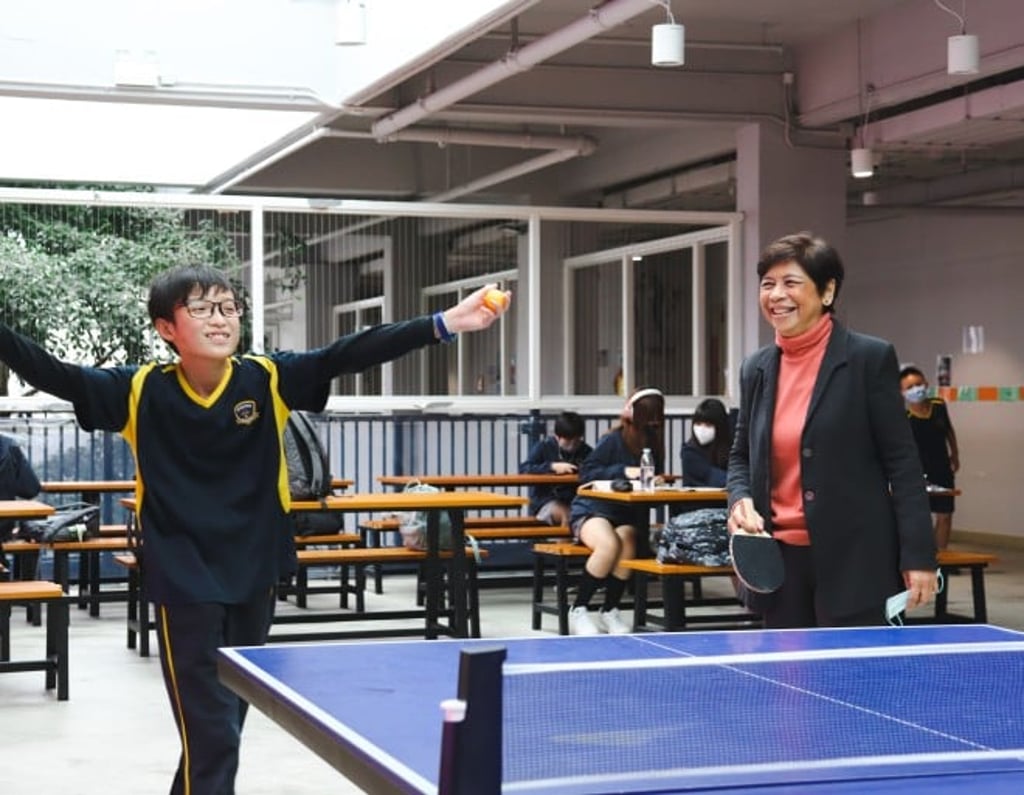 Mrs. Woo in a ping pong game with lower secondary school students