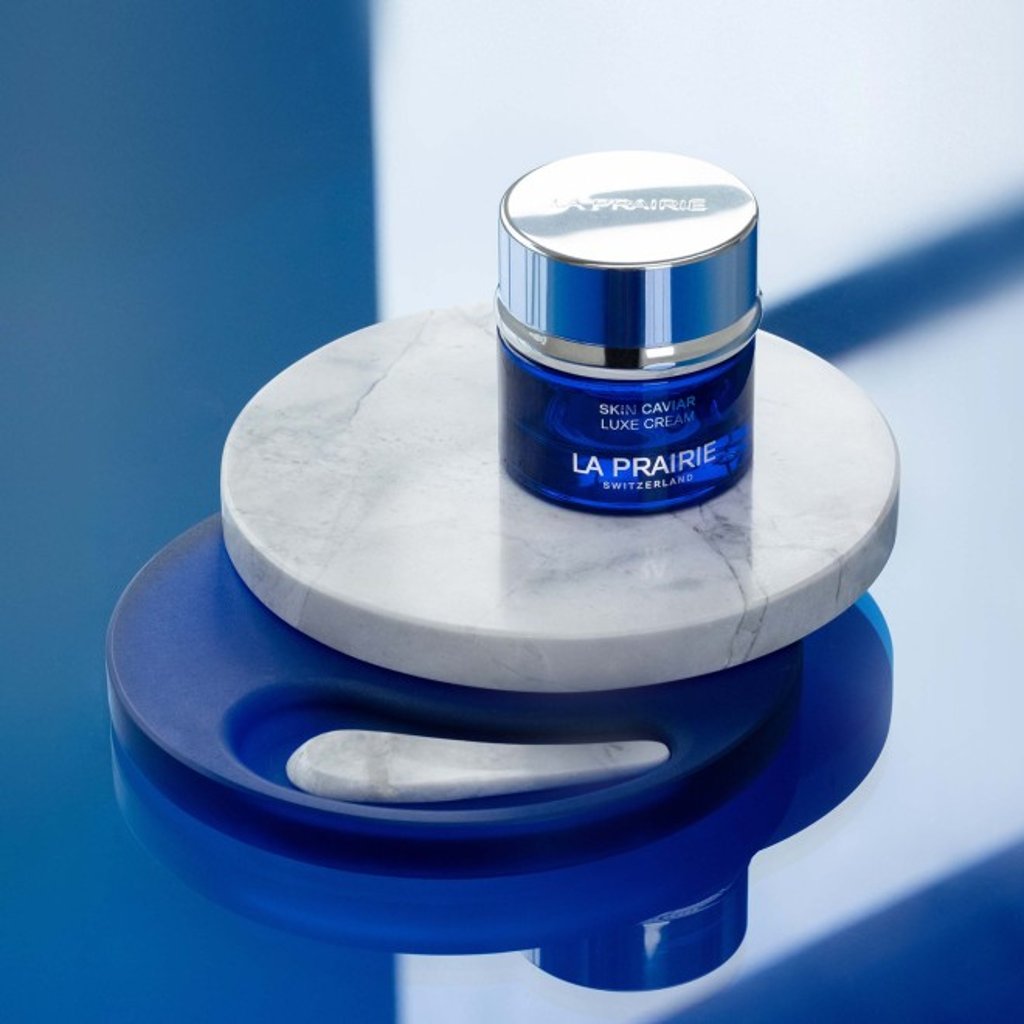 The bespoke limited-edition skincare object features an elegant, round swivelling tray and organically-shaped spatula.