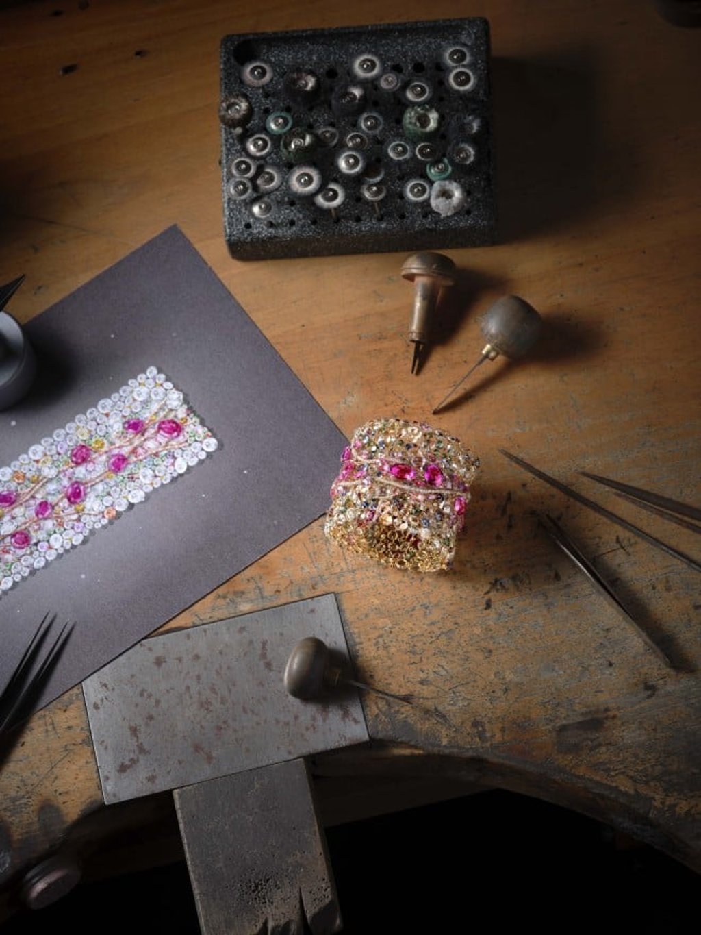 The intricate Spring Riverside Bangle dazzles with the vibrant colours of 1,936 gemstones, including pink sapphires, white and yellow diamonds, garnets, tsavorites and Paraiba tourmalines.