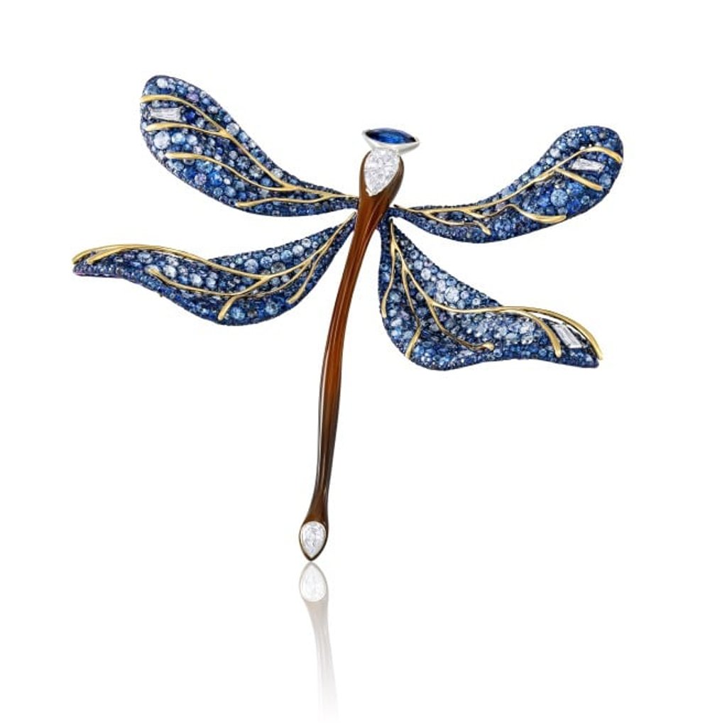 The whimsical Dragonfly Brooch features a harmonious blend of lightweight titanium and lustrous ox horn. The whimsical Dragonfly Brooch features a harmonious blend of lightweight titanium and lustrous ox horn.