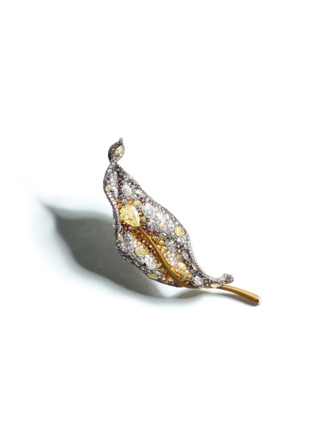 The Four Seasons Leaf Brooch evokes the warm glow of sunlight bathing the leaf. The Four Seasons Leaf Brooch evokes the warm glow of sunlight bathing the leaf.