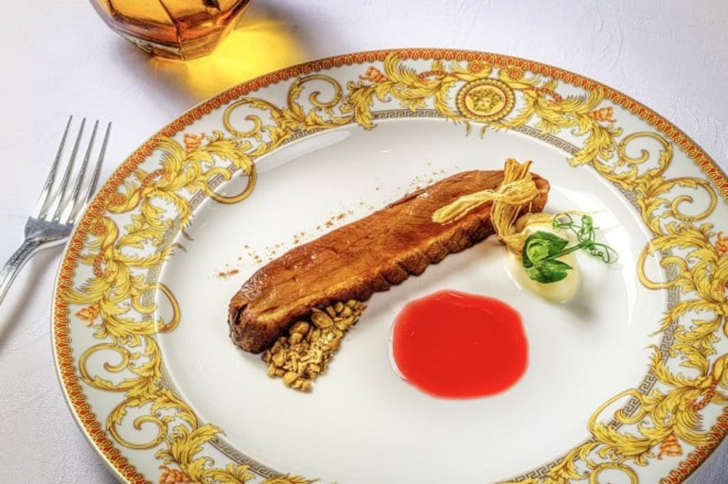 Filetto in crosta di pane: Medium-rare Alexandre Polmard heritage tenderloin, aged at -43°C, wrapped in bread crust with guanciale. Served with artichoke, spicy tomato sauce, and Italian salsa verde.