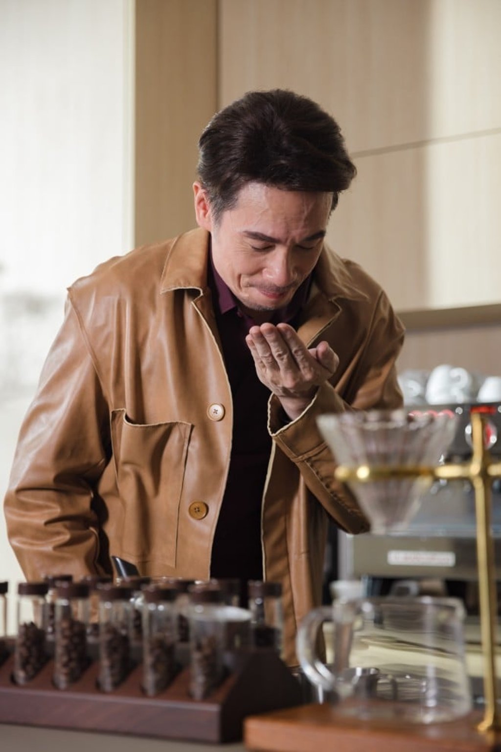 Chan enjoys a quiet moment with coffee, his passion project that reflects his dedication to quality and craftsmanship. Chan enjoys a quiet moment with coffee, his passion project that reflects his dedication to quality and craftsmanship.