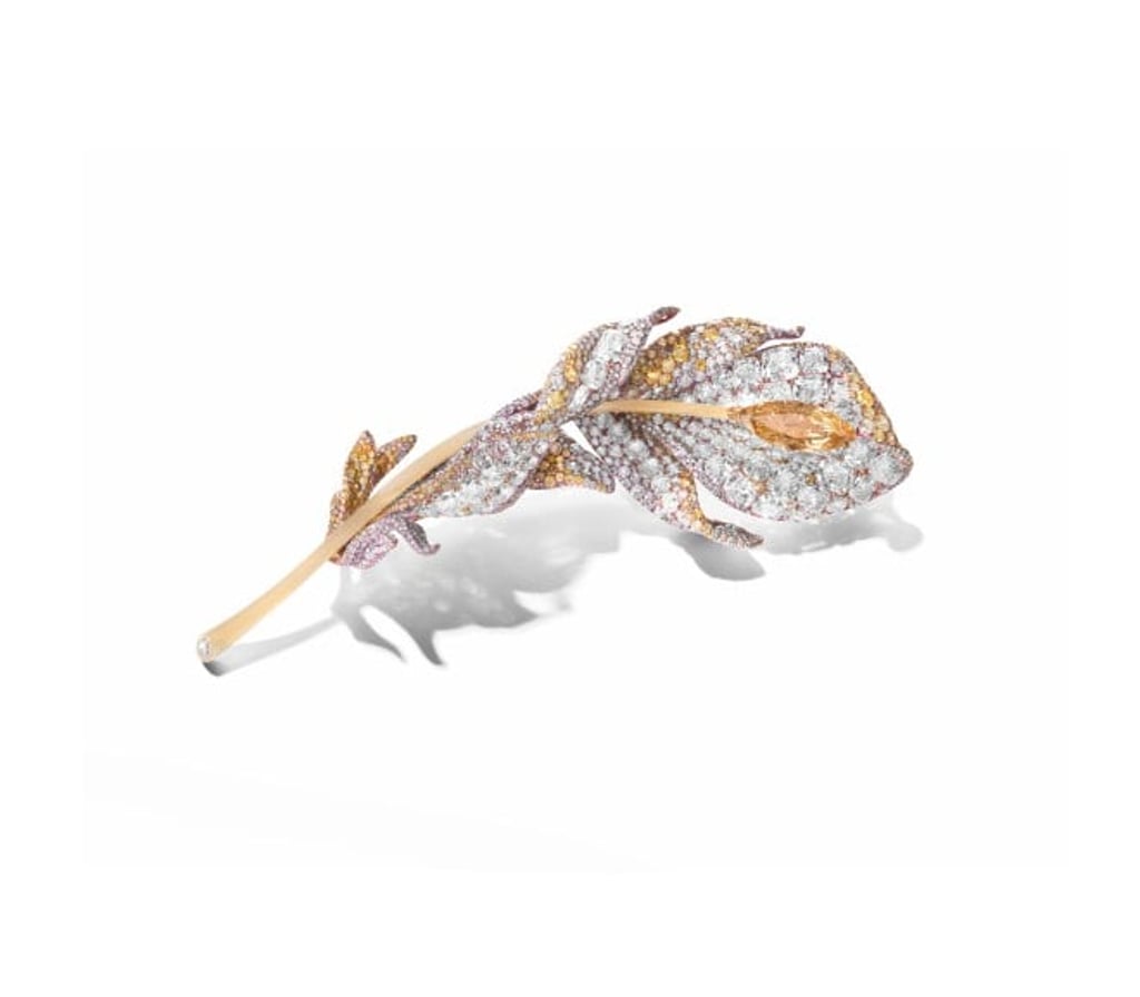 This Feather Brooch, set with a 4-carat marquise fancy brown-yellow diamond, along with white and yellow diamonds, pushes the boundaries of titanium craftsmanship with a dramatic 180-degree twist. This Feather Brooch, set with a 4-carat marquise fancy brown-yellow diamond, along with white and yellow diamonds, pushes the boundaries of titanium craftsmanship with a dramatic 180-degree twist.