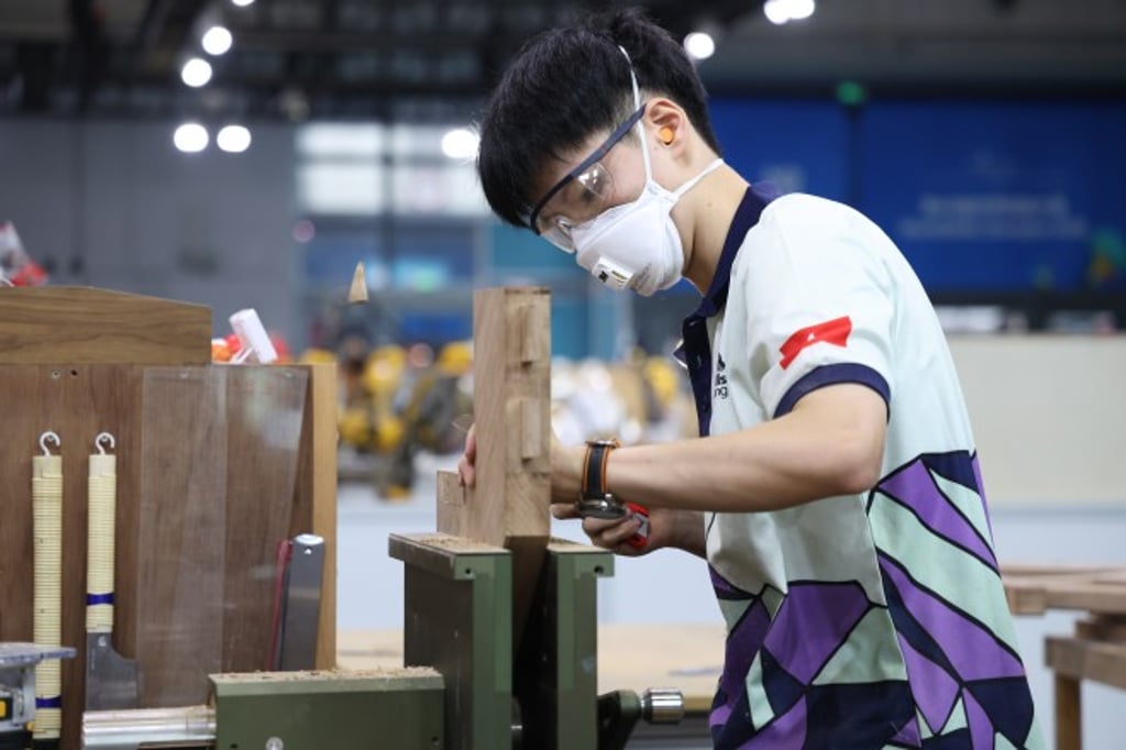 Huang Tsz-ho, Hong Kong’s joinery competitor, cuts a timber joint during WorldSkills Shanghai 2026. He had put a socialscience degree on hold to train for the contest.