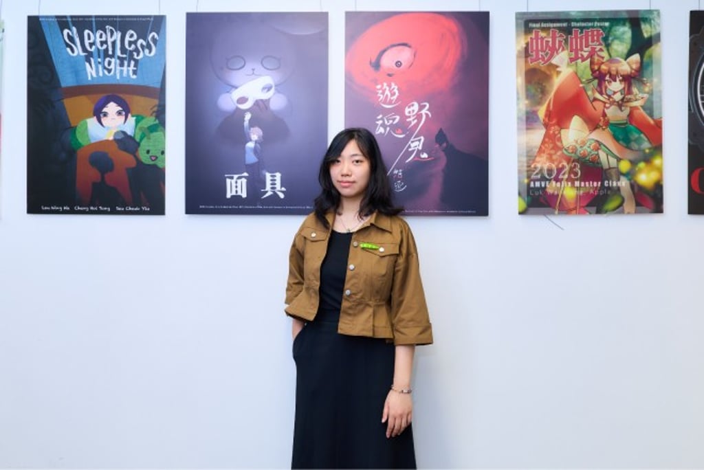 Hilary stands by a display of students’ creative works on the HKMU campus.