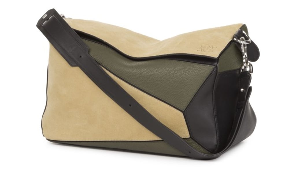 The iconic Puzzle bag in gold, military green and black crafted in grained calfskin and suede combines modernity with functionality. The iconic Puzzle bag in gold, military green and black crafted in grained calfskin and suede combines modernity with functionality.