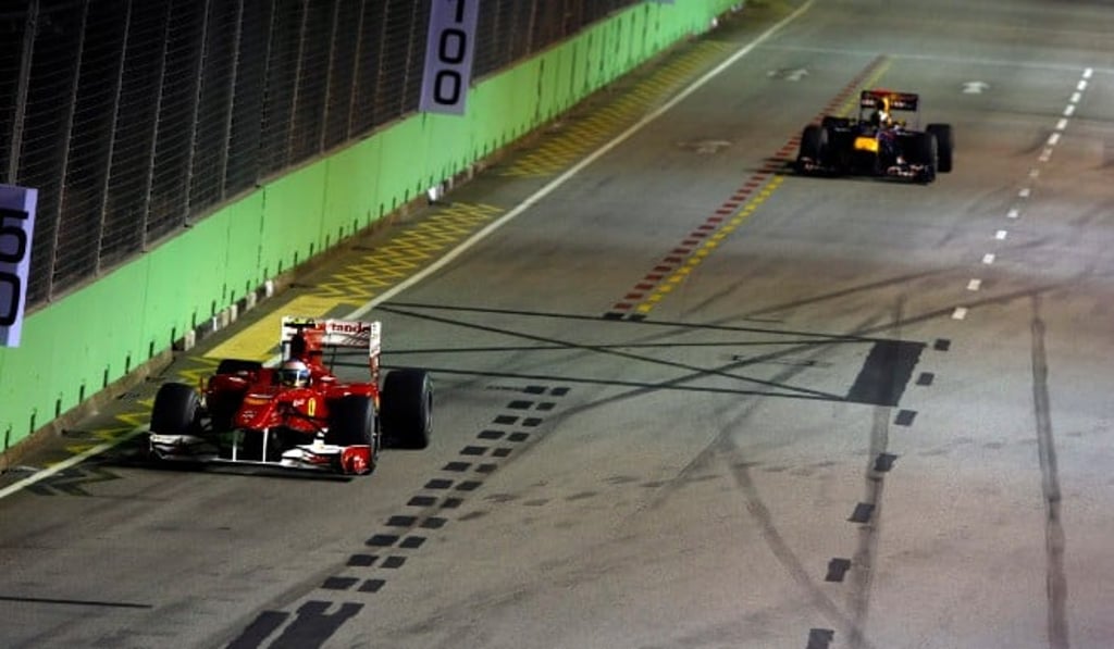 Ferrari’s Fernando Alonso leads Red Bull’s Sebastian Vettel