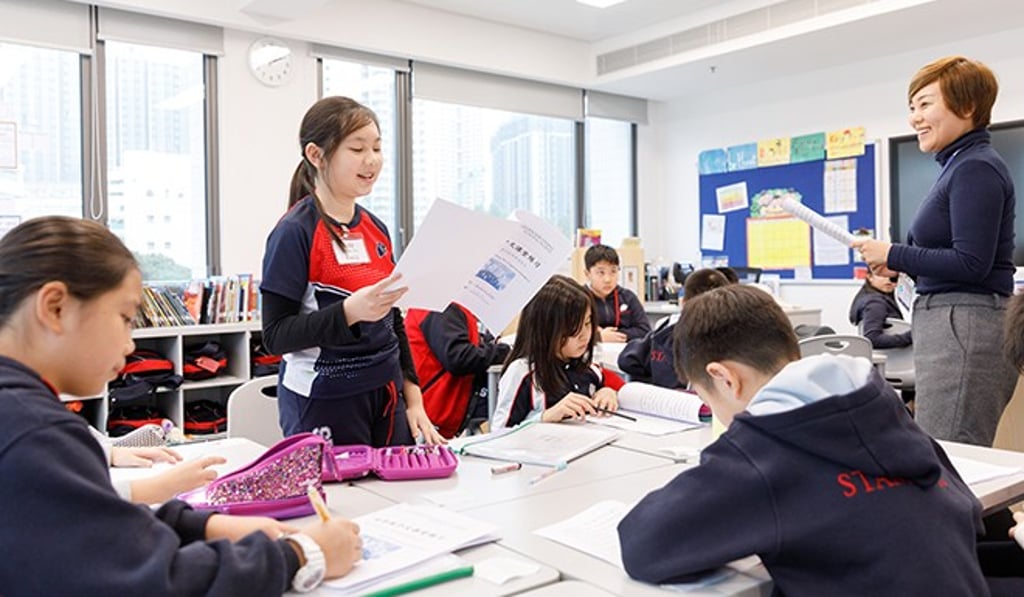 Head of Mandarin, Qian Wang working with an upper elementary student on spoken Mandarin