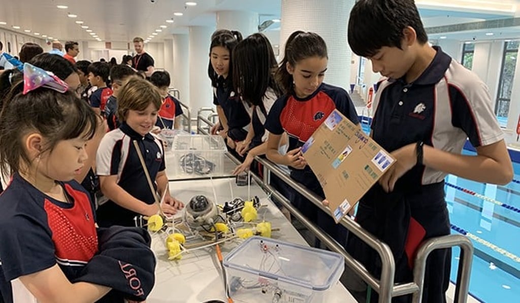 Older students share how their underwater vehicles work with younger students.