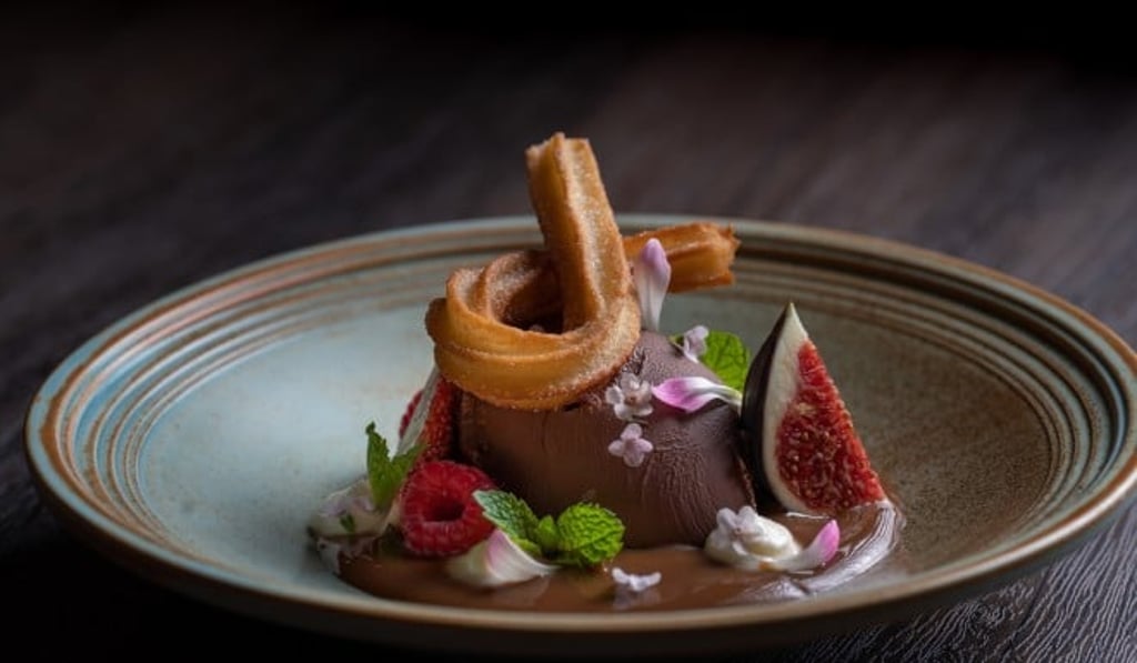 Olé adds a twist to the classic churro con chocolates, which is served with a rosemary-infused chocolate ganache.