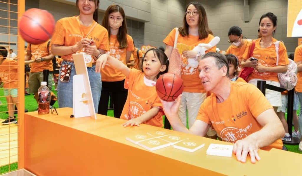 (First from right) Ian McLeod, Chief Executive of DFI Retail Group, plays with children at the “Let’s Get Healthy” Festival. (First from right) Ian McLeod, Chief Executive of DFI Retail Group, plays with children at the “Let’s Get Healthy” Festival.