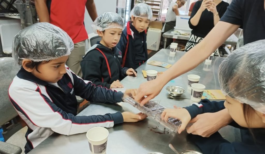 Students visited a local chocolate factory to learn about the processes behind different forms, engaging their five senses to better grasp abstract STEM concepts.