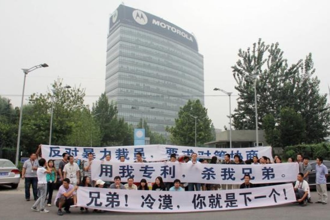 Staff from Motorola's Beijing office protest about lay-offs. A report says that up to 1,000 workers across the country may be cut. Photo: SCMP
