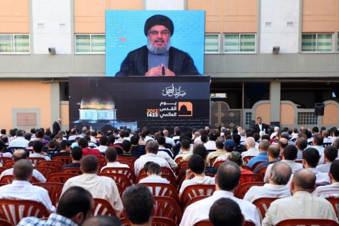 Hezbollah leader Hassan Nasrallah speaks via a video link in Lebanon, warning Israel of retaliation for any aggression.Photo: AP