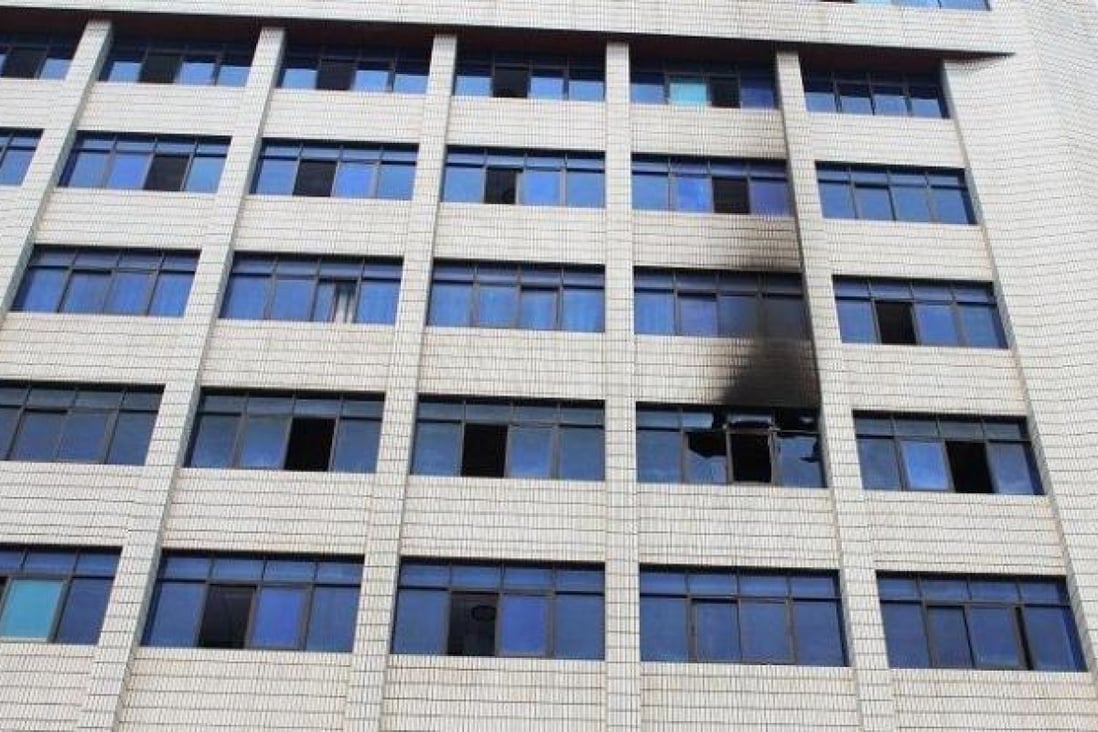 A smoke-blackened window is seen at an office building in Shaoyang city, Hunan, on Monday. Photo: SCMP Pictures