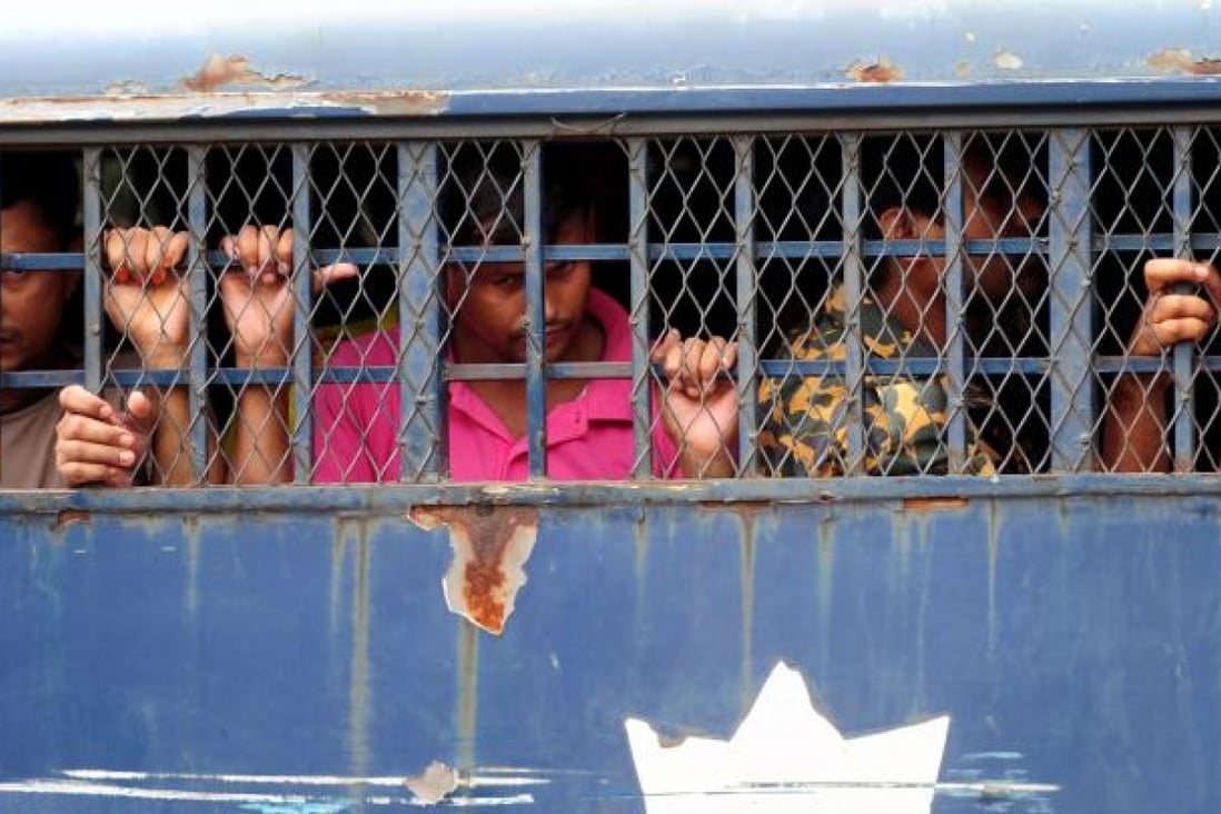 Bangladesh Border Guard soldiers on trial wait in a prison van at at the BDR headquarters in Dhaka. Photo:AFP 