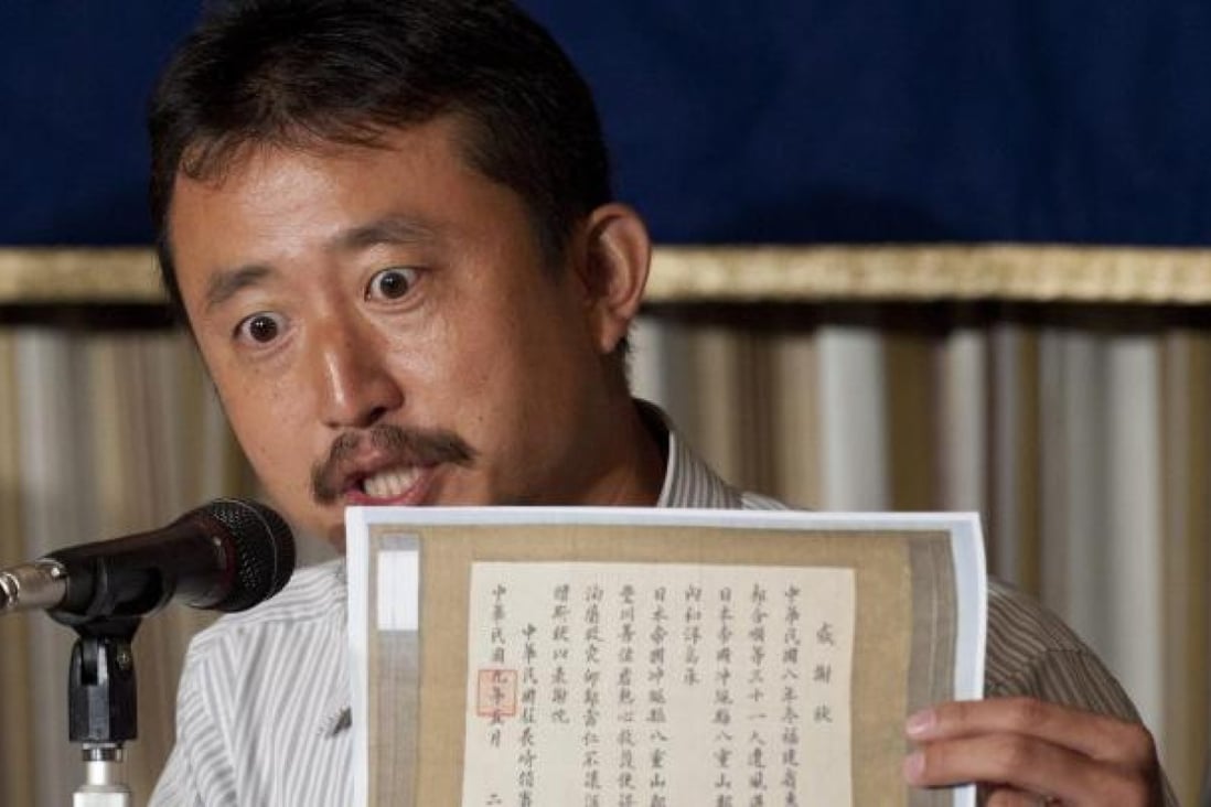 Politician Eiji Kosaka yesterday shows the media a document that he says proves the disputed Diaoyu Islands belong to Japan. Photo: EPA