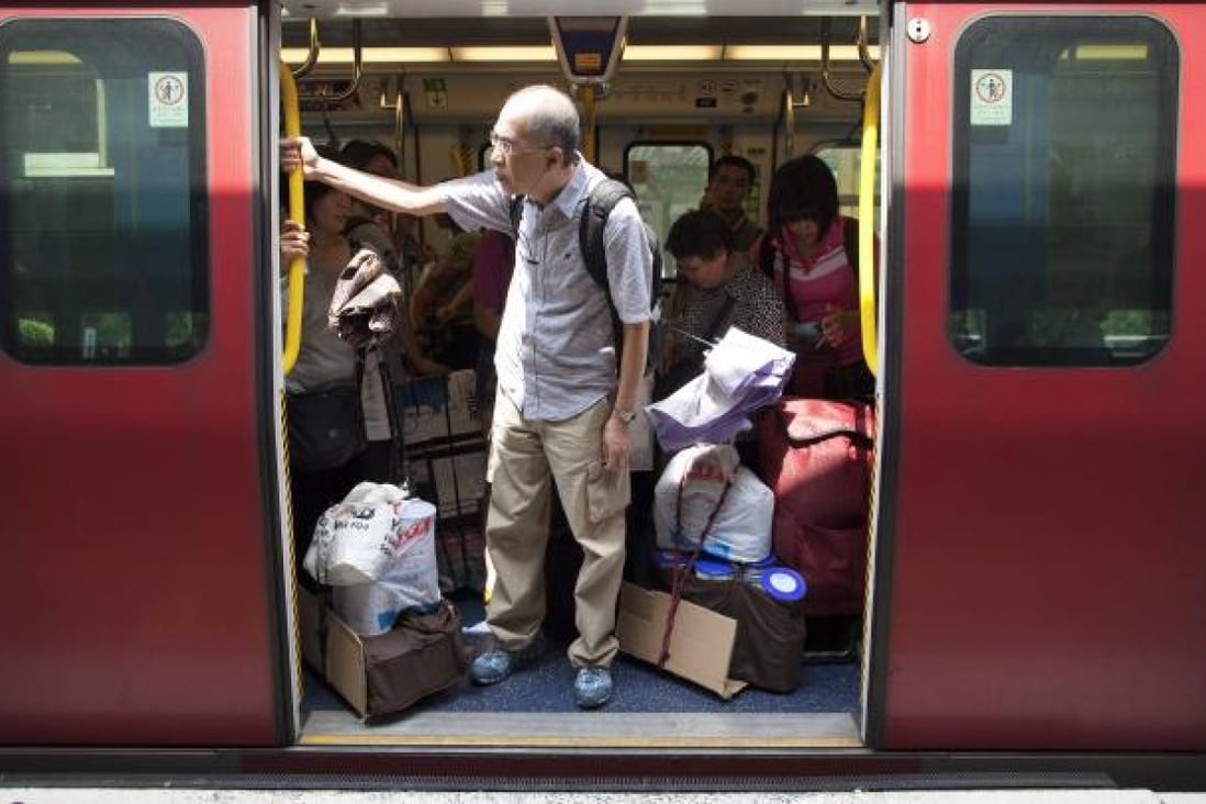Mainland visitors board a train in Sheung Shui with goods bought in Hong Kong. Photo: EPA