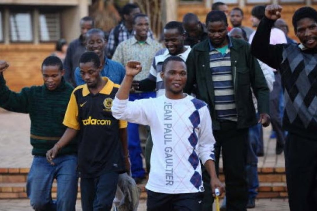 Mine workers celebrate their release at Ga-Rankuwa Magistrate's Court in Pretoria, South Africa, on Monday. Photo: AFP