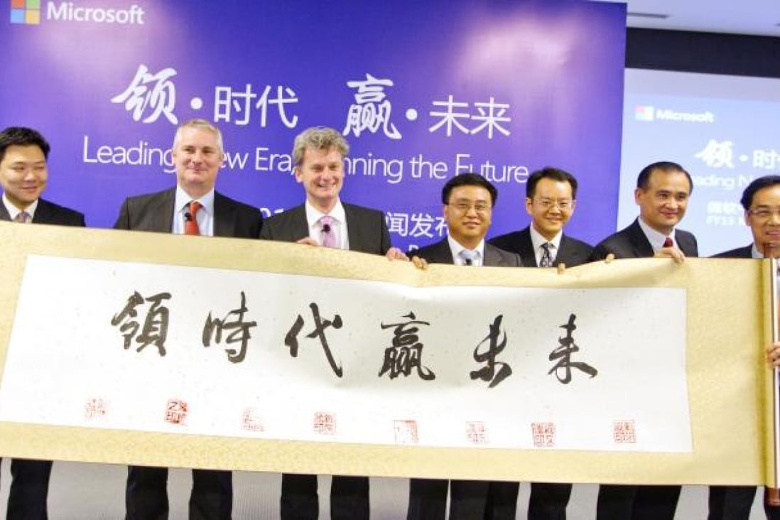 A group of Microsoft's executives hold a Chinese scroll at the company's press briefing in Beijing yesterday. Photo: Simon Song
