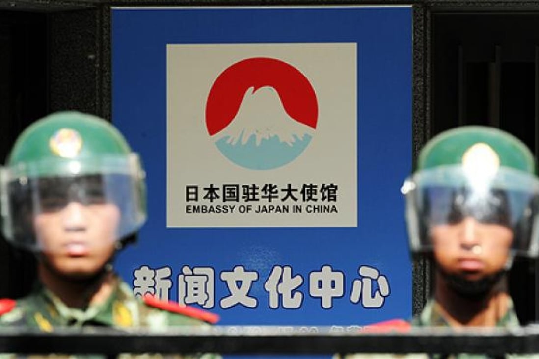 Beijing riot police stand guard the Japanese embassy on Sunday as protesters rally outside after Tokyo announced it had bought the Diaoyu islands. Photo: AFP