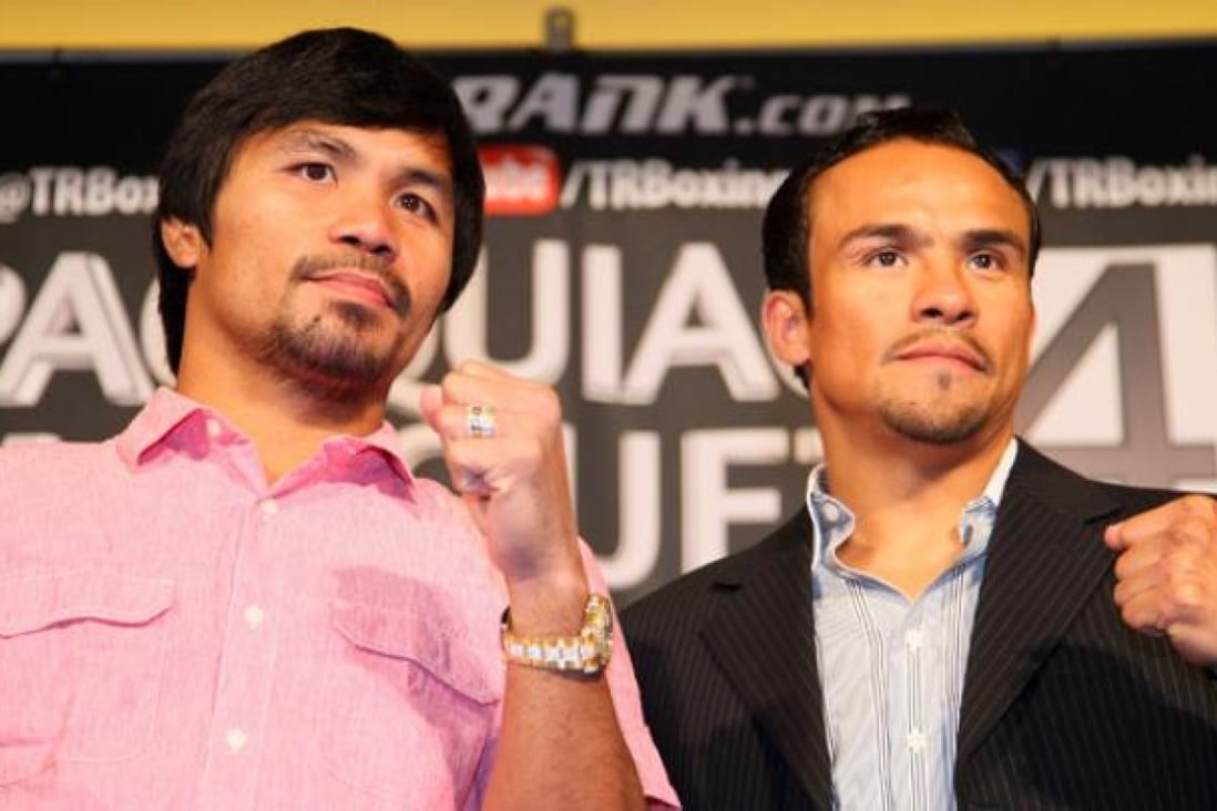 Manny Pacquiao, left, and Juan Manuel Marquez face the media cameras during a Press Conference at Beverly Hills Hotel in California on Monday. Photo: AFP