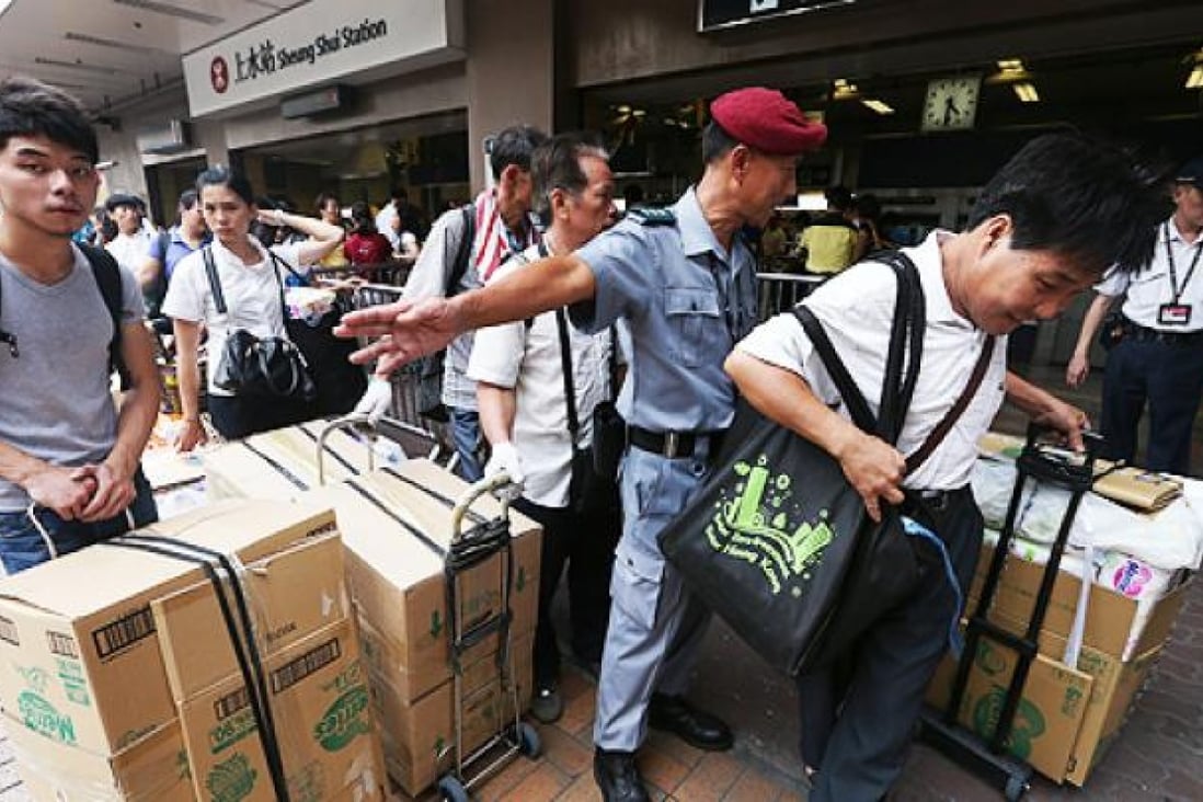 Parallel goods traders take their wares aboard the train at Sheung Shui railway station. Photo: Sam Tsang
