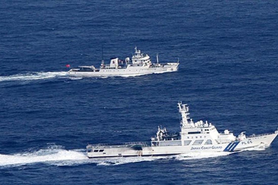 The Japanese coastguard (bottom) and a Chinese fisheries patrol boat sail near the disputed islands in the East China Sea last week. Photo: AP