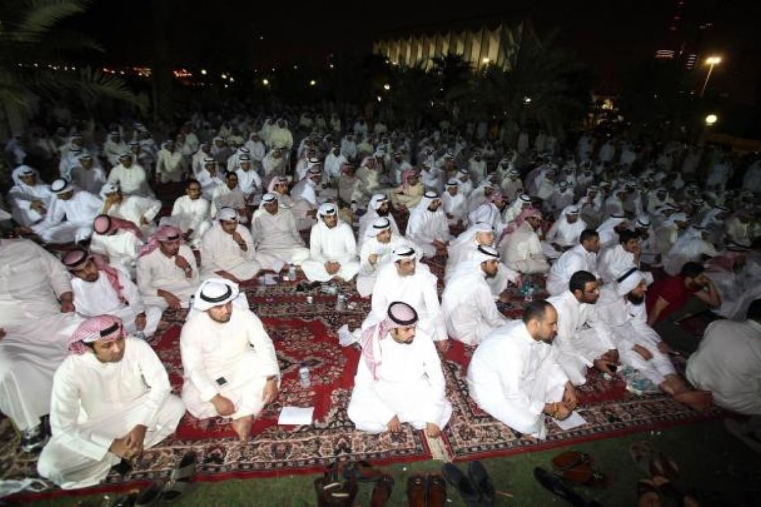 Kuwaiti men protest in front of the parliament. Photo: AFP