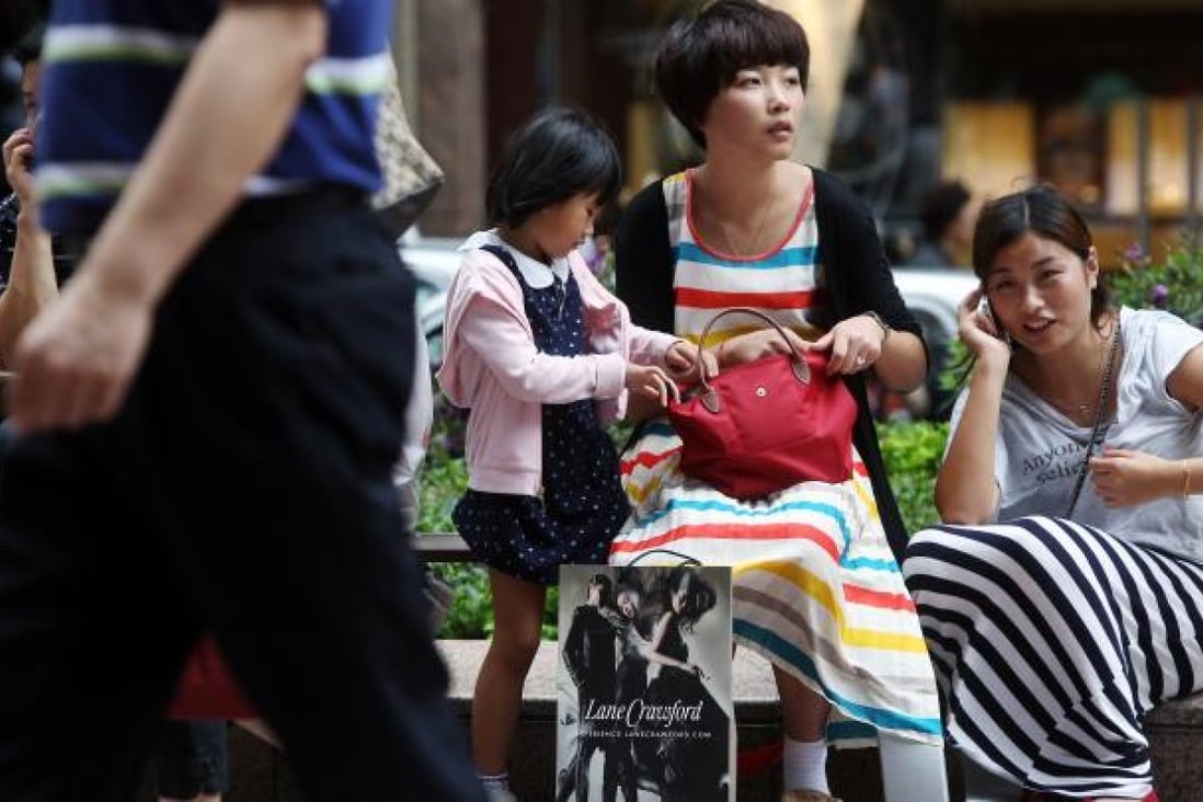 A mainland Chinese family outside Times Square, Hong Kong. Photo: SCMP