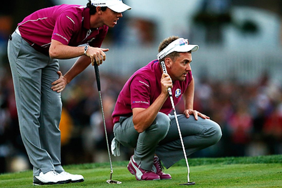 Rory McIlroy and Ian Poulter of Europe line up a putt on the 18th green at Medinah Country Club in Chicago, Illinois, on Saturday. Photo: AFP