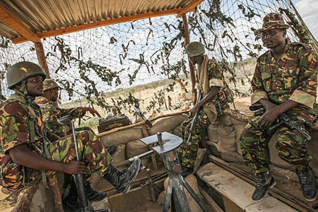 Soldiers of the Kenyan contingent serving with the African Union Mission in Somalia sit in a watch tower in Dhobley, southern Somalia. Photo: EPA
