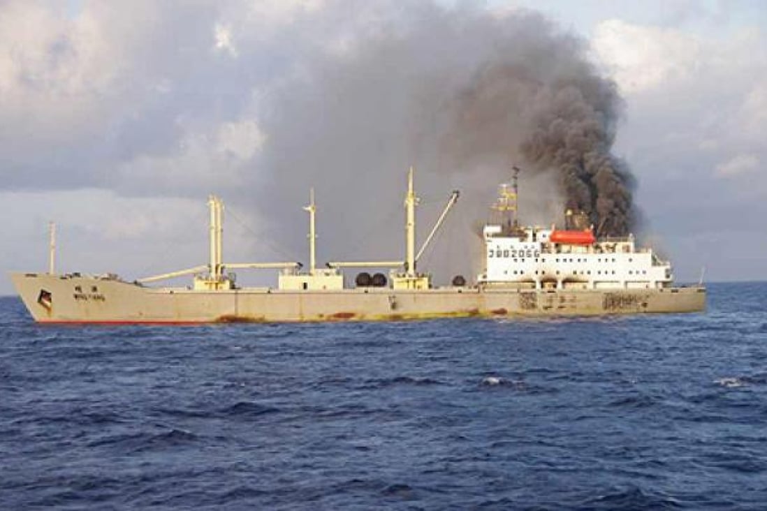 Smoke rises from a Chinese cargo ship after an explosion on Saturday. Photo: AFP