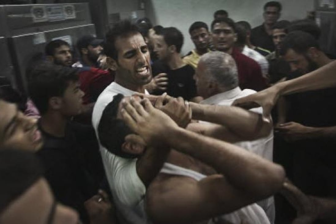 A Palestinian man reacts to the death of his relative, one of two Palestinian militants killed in an Israeli air strike, in the Jabaliya Refugee Camp in the northern Gaza Strip. Photo: EPA