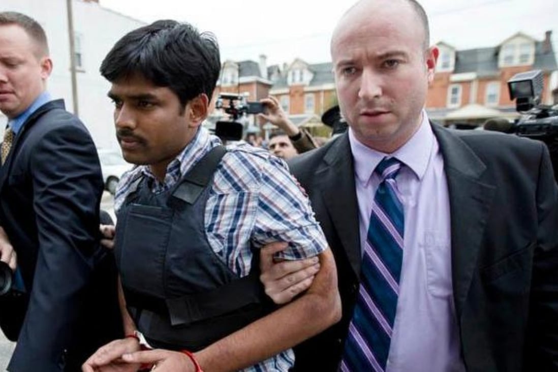 Raghunandan Yandamuri is led into court in a bullet-proof vest.