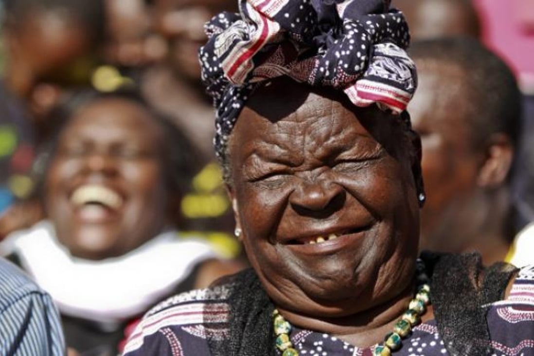 US President Barack Obama's step-grandmother Sarah Onyango Obama (right) smiles during a press conference held after Obama's victory was announced in Nyang'oma Kogelo village, in western Kenya on Wednesday. Photo: EPA