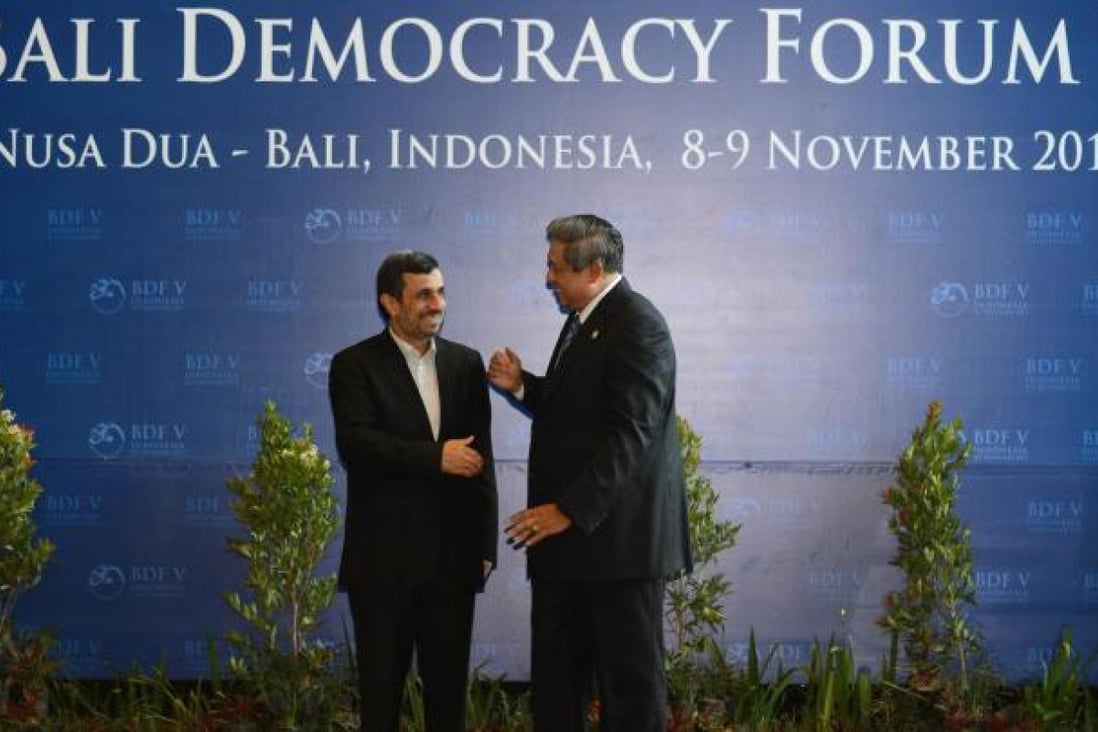 Iranian President Mahmoud Ahmadinejad speaks to Indonesian President Susilo Bambang Yudhoyono at the forum yesterday. Photo: AFP
