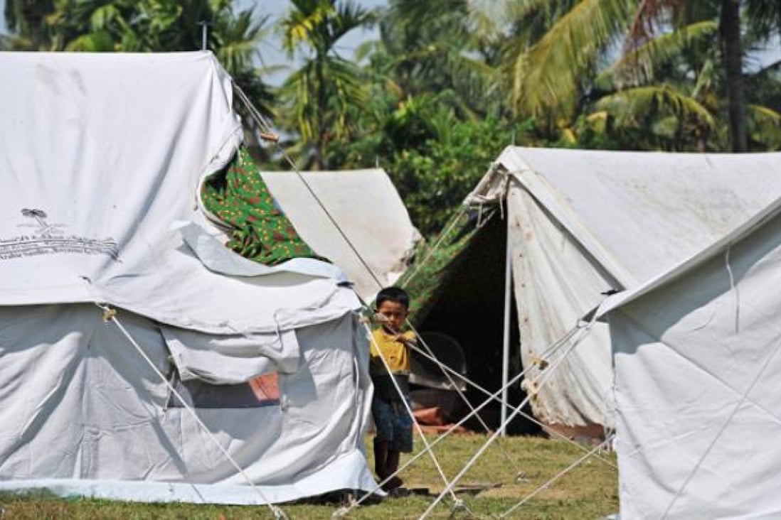 A Ethnic Rakhine child stands beside a tent in Mayebon Internally Displaced Persons (IDP) camp in Rakhine state on November 1. Photo: AFP