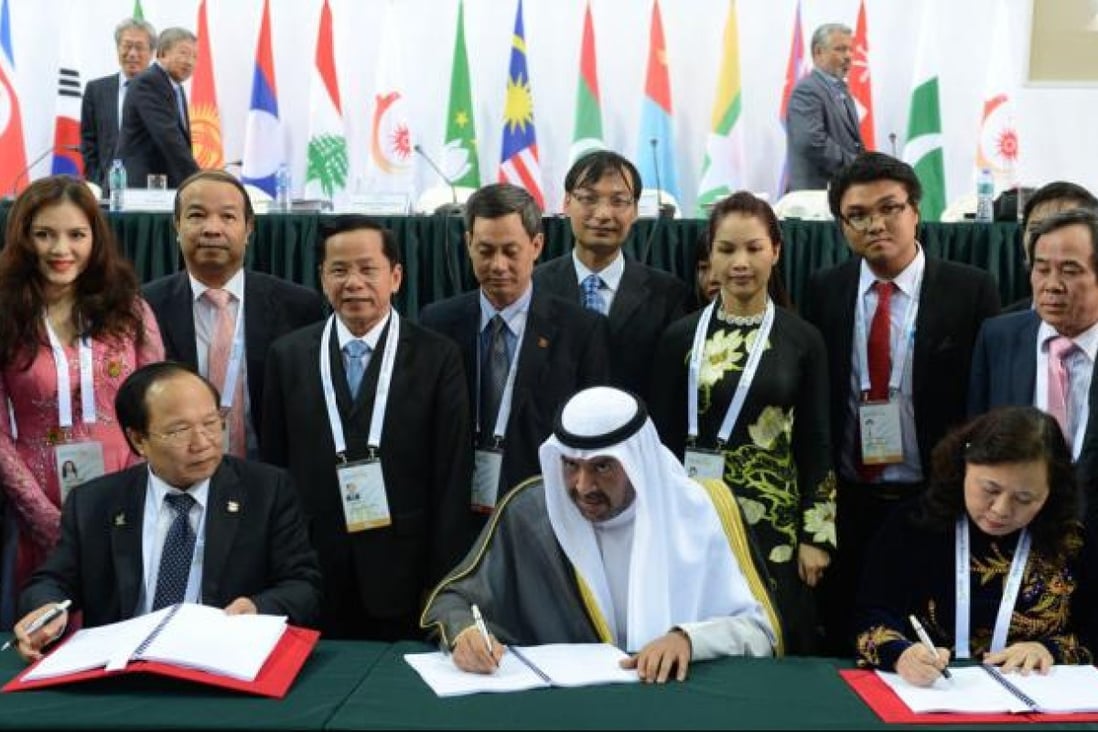 President of OCA Sheikh Ahmad (front centre) signs an agreement with the delegates of Vietnam during the OCA's general assembly.