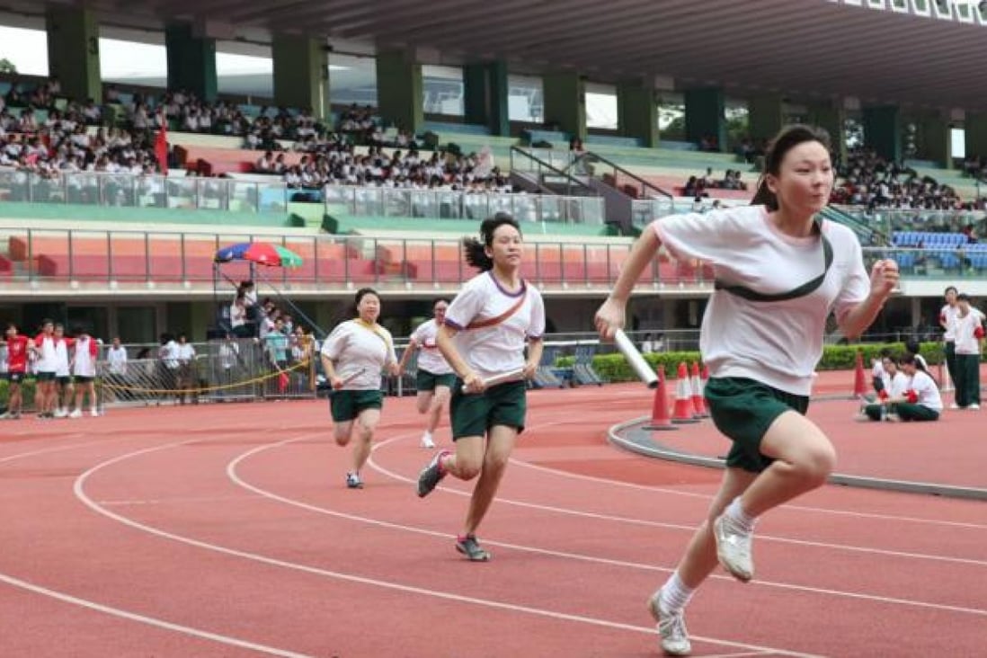 Students race to the finishing line at Wan Chai Sports Ground.  