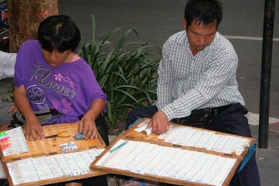 Lottery ticket vendors ply their trade on a Bangkok street.