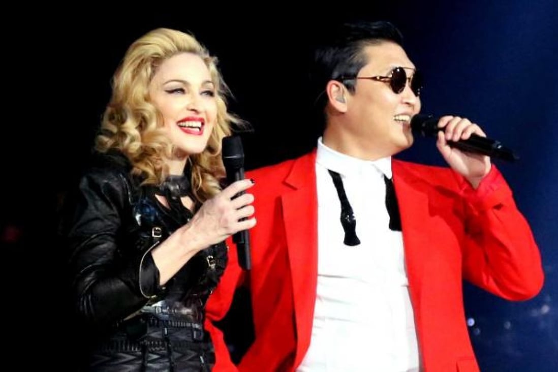 Singer Madonna, left, is shown on stage with South Korean rapper PSY during Madonna's MDNA concert at Madison Square Garden in New York. Photo: AP