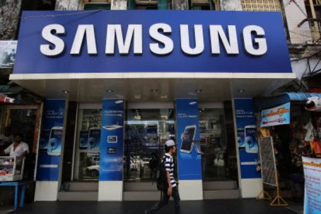 A pedestrian walks past a Samsung Electronics retail store in Yangon, Myanmar, on November 20, 2012. Photo: Bloomberg