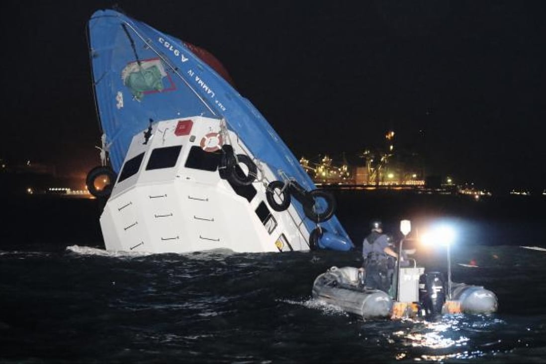 The stricken Lamma IV is half-submerged after the collision.