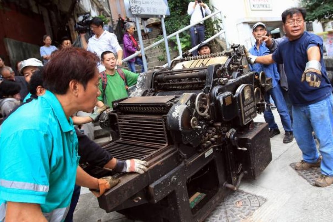 The Original Heidelberg Cylinder Letter Press Machine is moved from the closing Wai Che Printing Company yesterday. Photo: Jonathan Wong
